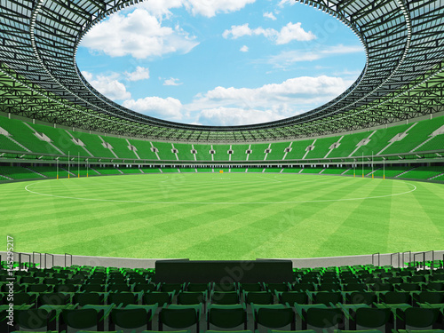 3D render of a round Australian rules football stadium with green seats and VIP boxes