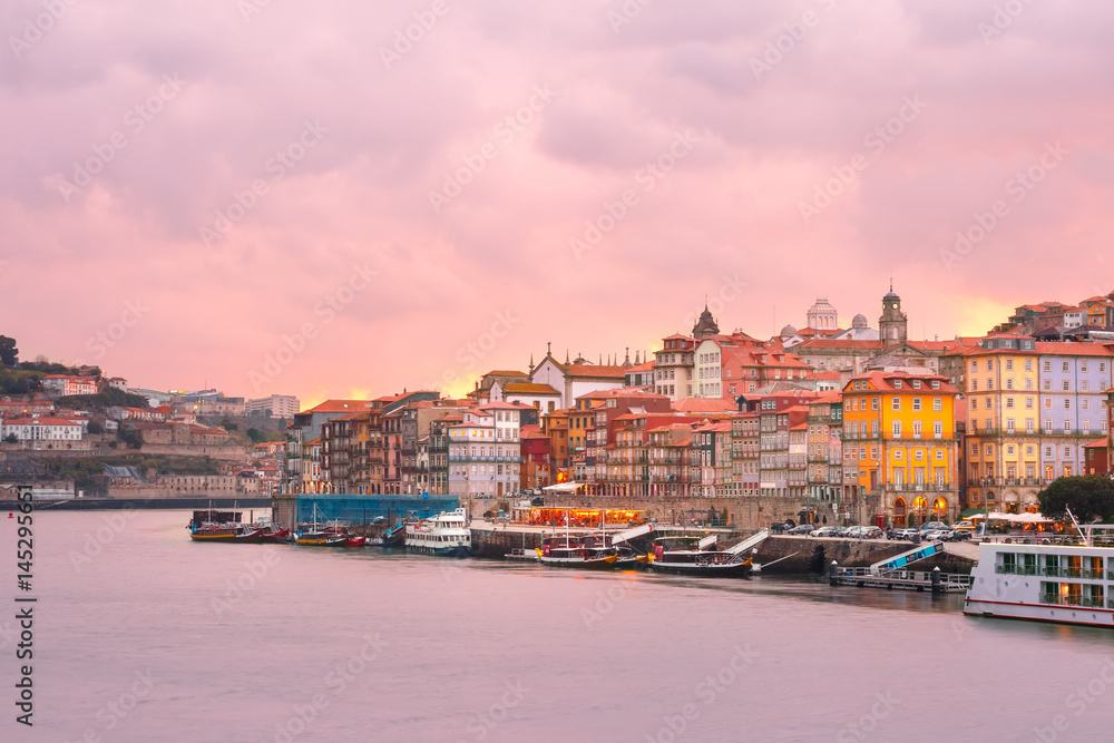 Ribeira and Old town of Porto with mirror reflections in the Douro River at sunset, Portugal, Portugal.