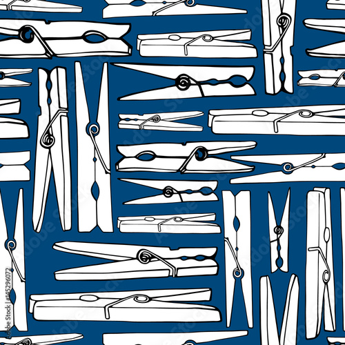 Old clothespins on a blue background. Seamless background.