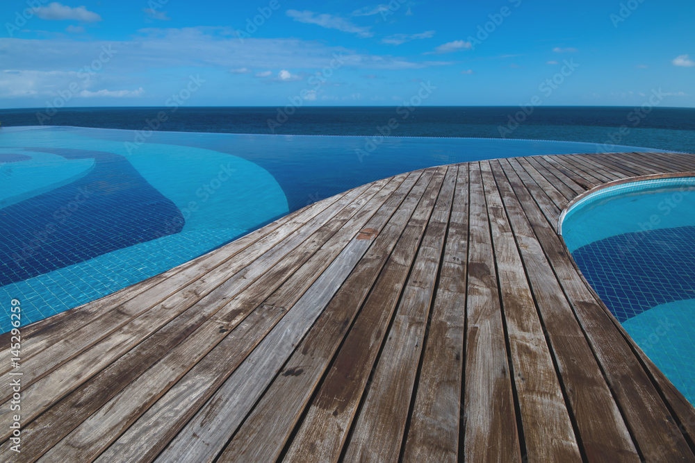 Fototapeta premium Ocean view from infinity pool with wood deck