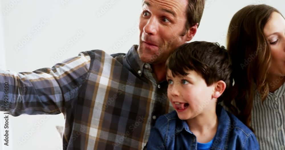 Happy family taking a selfie on mobile phone Happy family taking a selfie on mobile phone