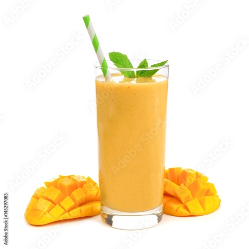 Healthy mango smoothie in a glass with mint and straw isolated on white