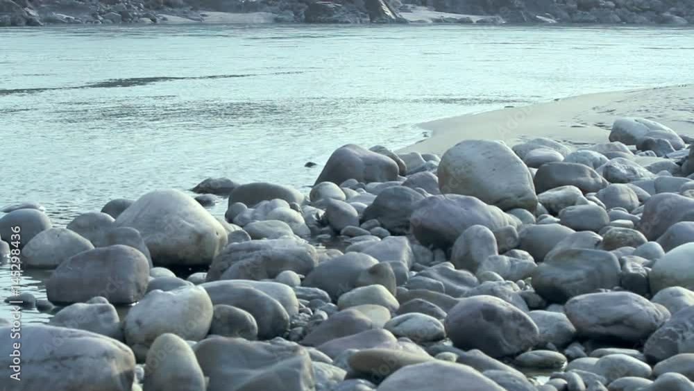 A shot of the sacred River Ganges flowing past rocks at the holy town of Rishikesh in North India. A shot of the sacred River Ganges flowing past rocks at the holy town of Rishikesh in North India.