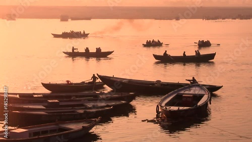 Boats sail as the sun sets over the River Ganges at Varanasi, India.