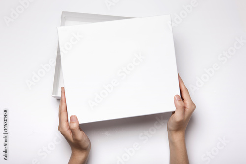 woman hand hold a white gift box isolated white. © dohee