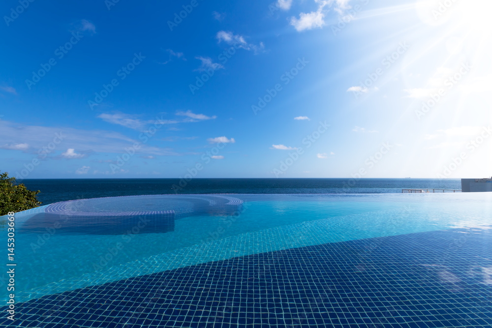 Beautiful view of infinity pool with sea and blue sky