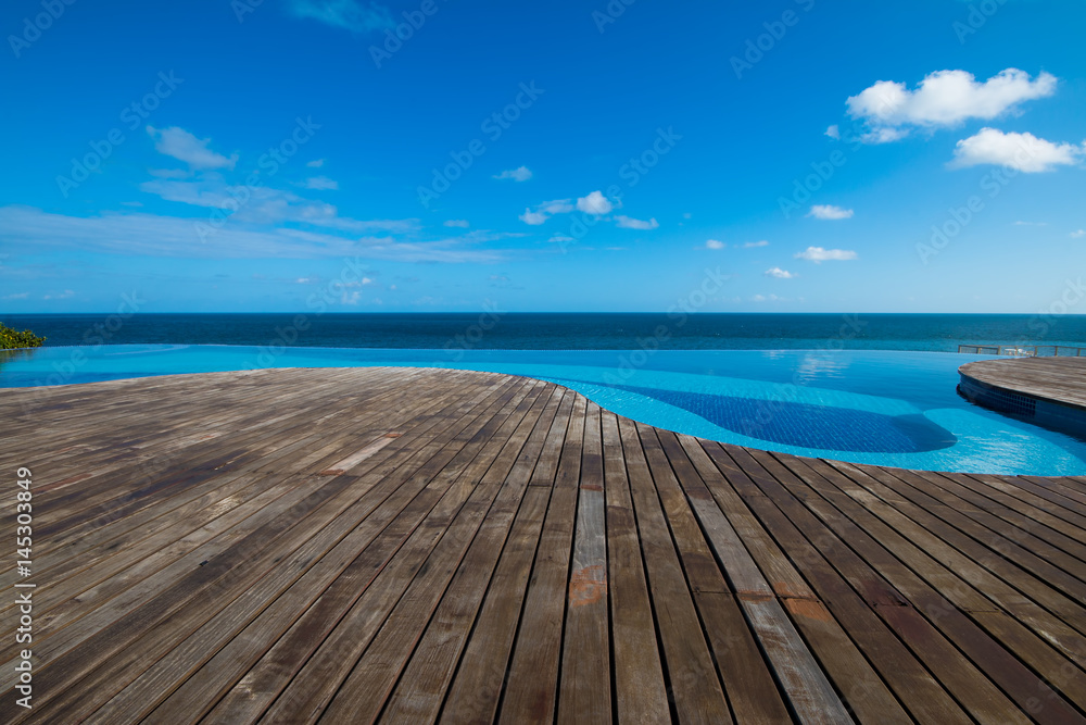 Naklejka premium Infinity pool with wood deck