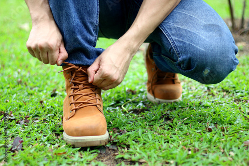 Men are tying a shoelace