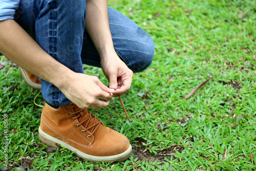 Men are tying a shoelace