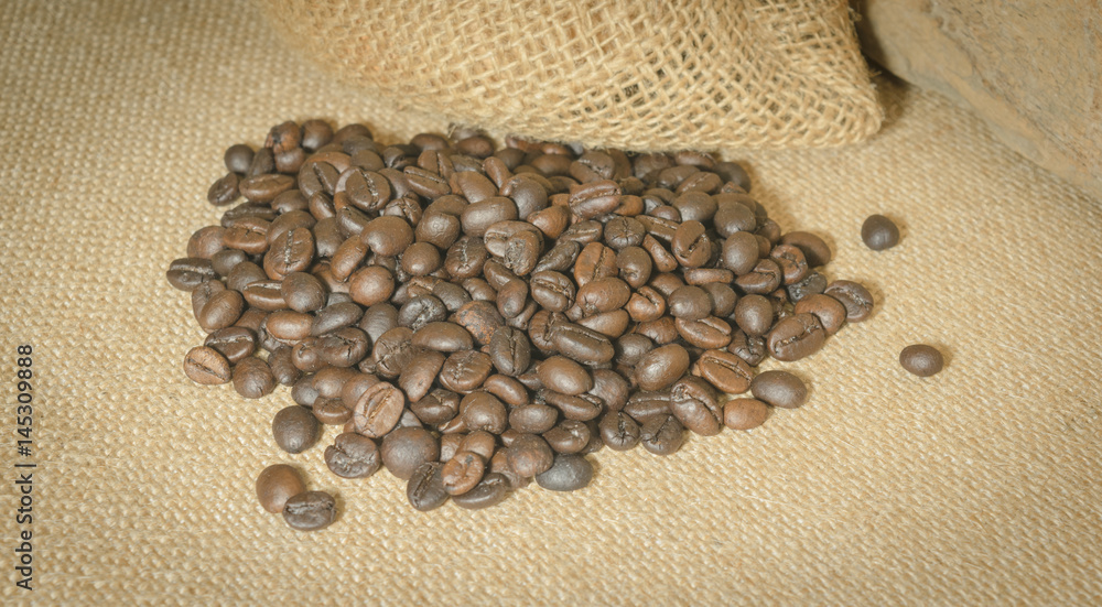 Coffee beans lay under sacks. Concept coffee lover. Coffee beans lay under sacks. Concept coffee lover.