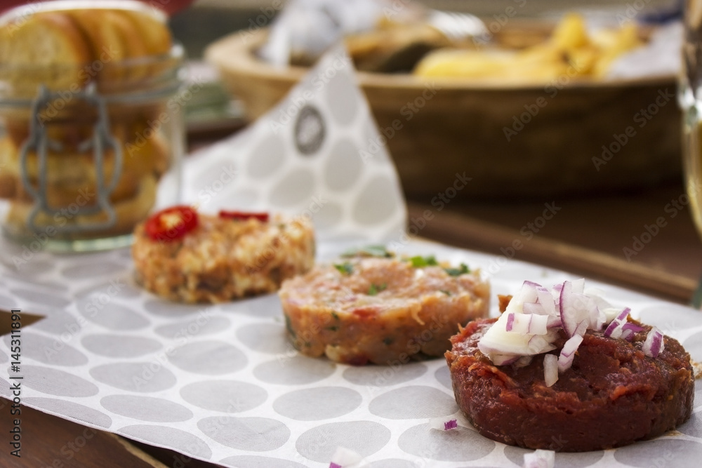 Delicious chicken, beef tartar spread over the table Delicious chicken, beef tartar spread over the table