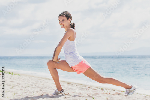 sporty woman doing leg stretching before workout