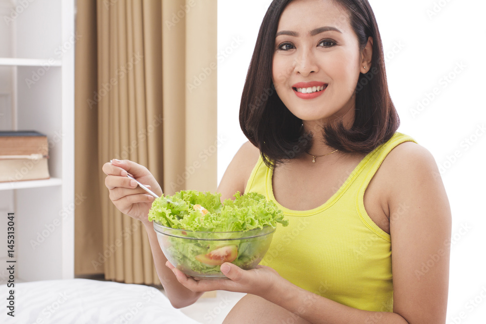 healthy pregnant woman eating fresh salad for breakfast healthy pregnant woman eating fresh salad for breakfast