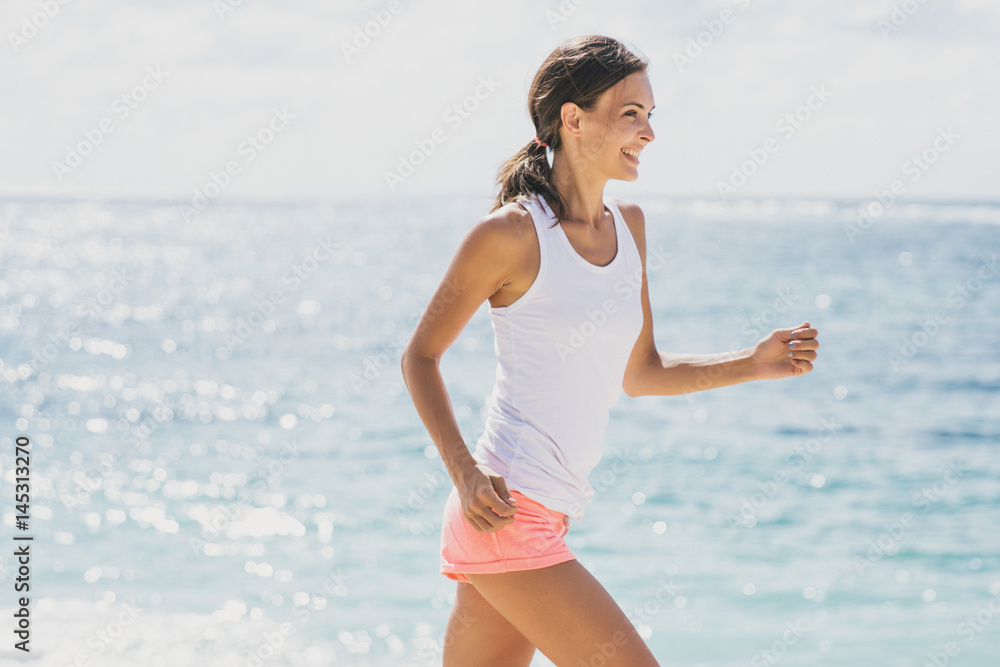 happy sporty woman jogging with skies and sea at the background happy sporty woman jogging with skies and sea at the background