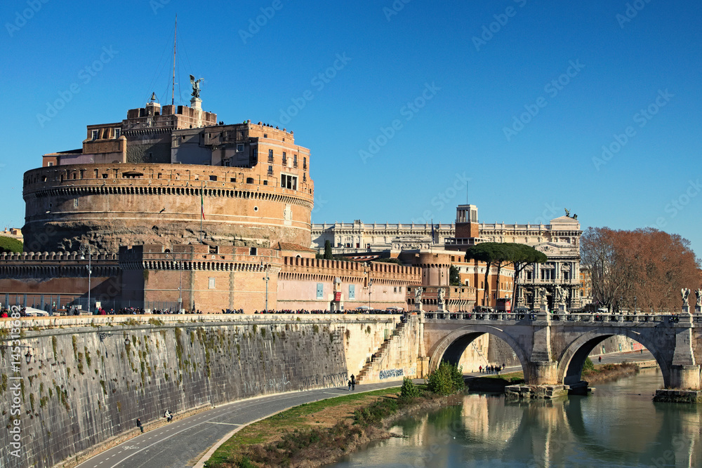 Castle of Holy Angel (Castel Sant Angelo) and Holy Angel Bridge over the Tiber River in Rome at sunny winter day. Rome. Italy