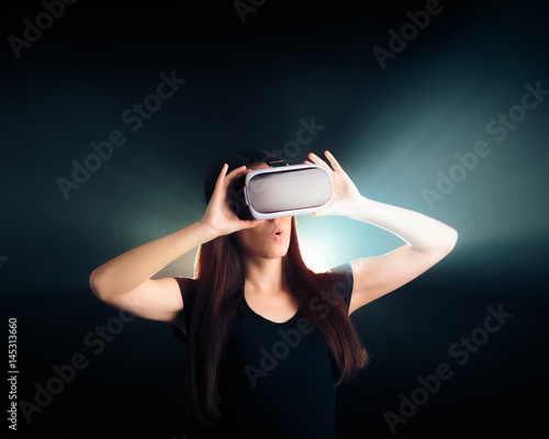Woman with VR Glasses Headset Enjoying the Virtual Reality Experience  © nicoletaionescu
