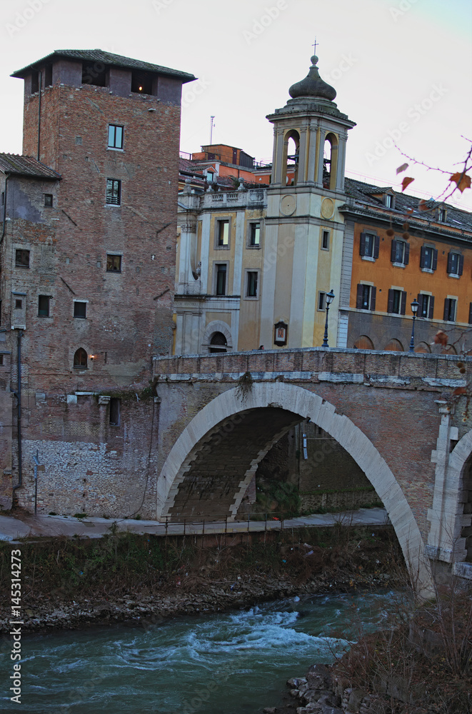 Naklejka premium The Tiberina Island and the Pons Fabricius or Ponte dei Quattro Capi, is the oldest Roman bridge in Rome, 62 BC. Rome, Italy
