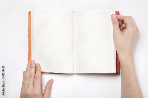 woman hand hold a book(note) with a leaf isolated white.