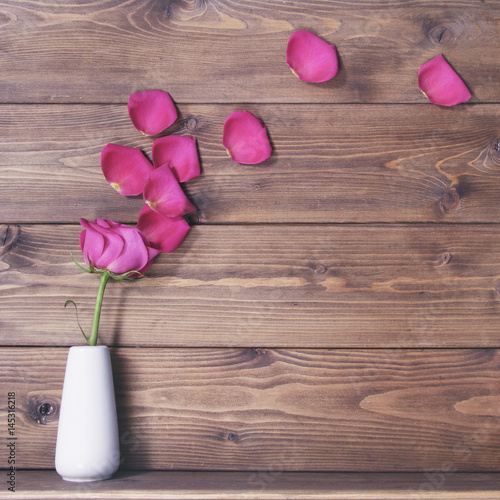 Fototapeta Naklejka Na Ścianę i Meble -  Wooden background witn pink rose on vase