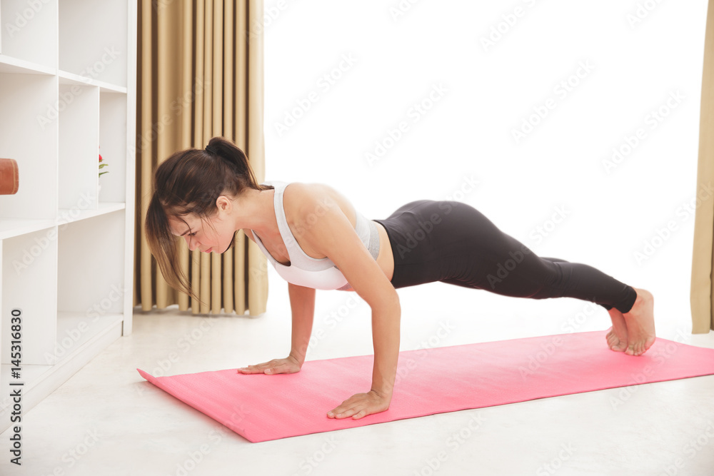 young sporty girl doing plank exercise young sporty girl doing plank exercise