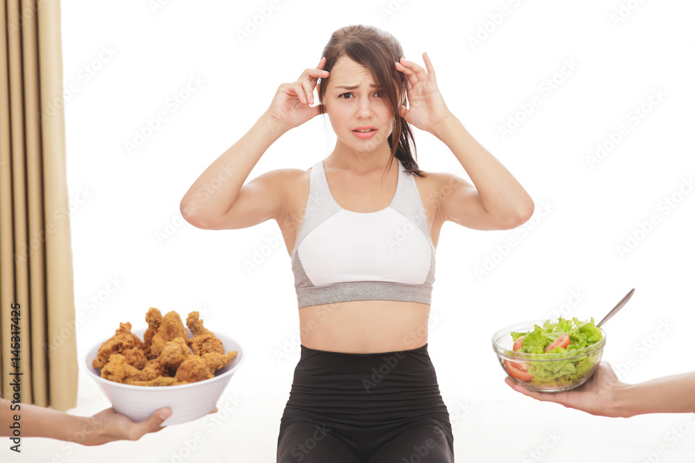 sporty girl confuse to choose a meal on diet process sporty girl confuse to choose a meal on diet process