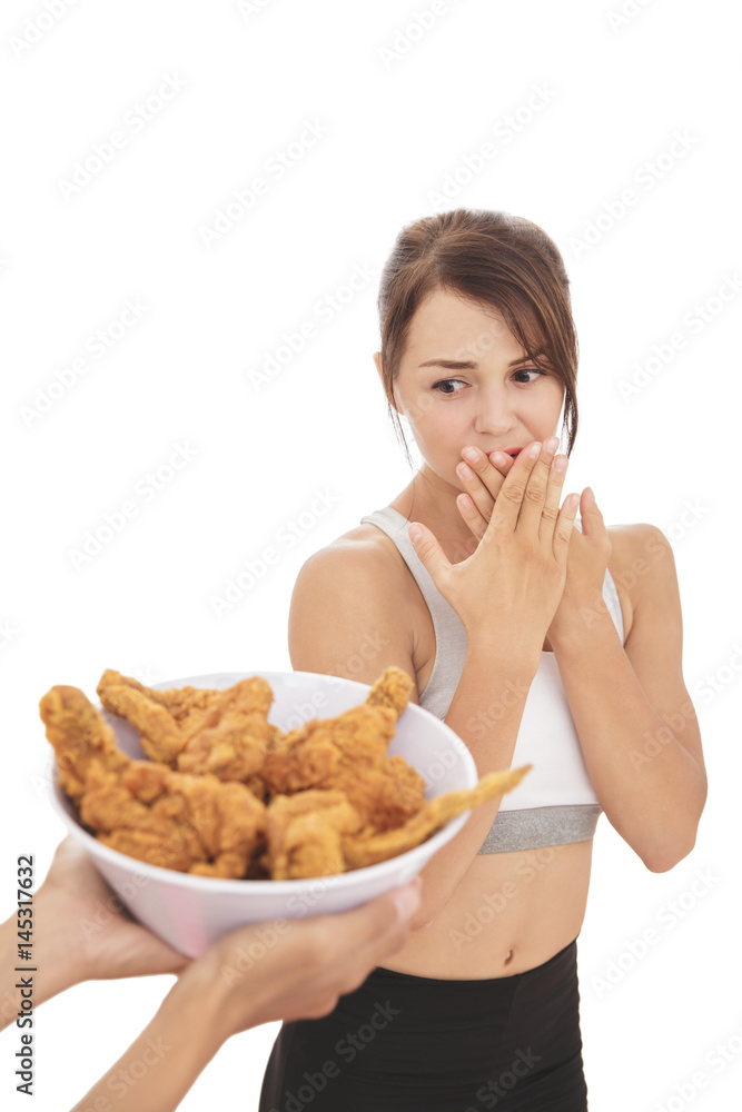 young sporty woman resisting the temptation of fried chicken young sporty woman resisting the temptation of fried chicken