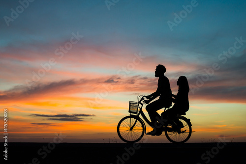 Silhouette young couple in love enjoy good time together during sunset.