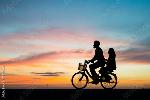 Silhouette young couple in love enjoy good time together during sunset.