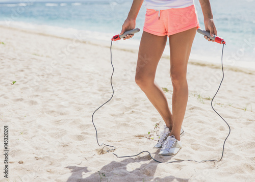 hands of sporty woman holding skipping rope