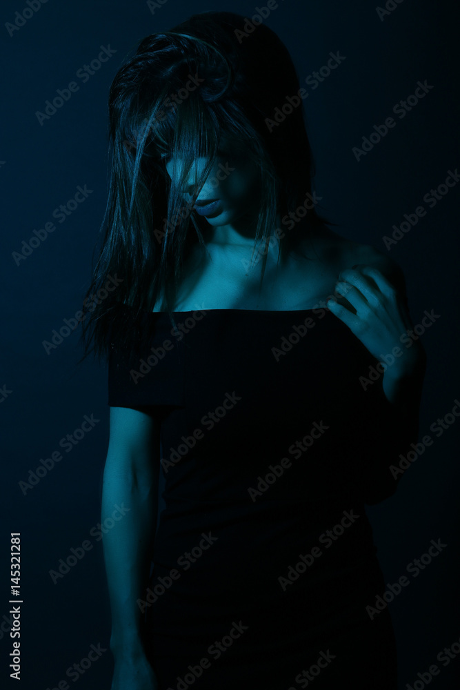 Beautiful woman wearing a black dress in a nightclub Beautiful woman wearing a black dress in a nightclub