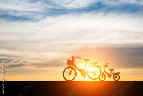 Two Silhouette vintage bicycle at sunset.