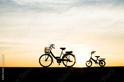 Fototapeta Naklejka Na Ścianę i Meble -  Two Silhouette vintage bicycle at sunset.