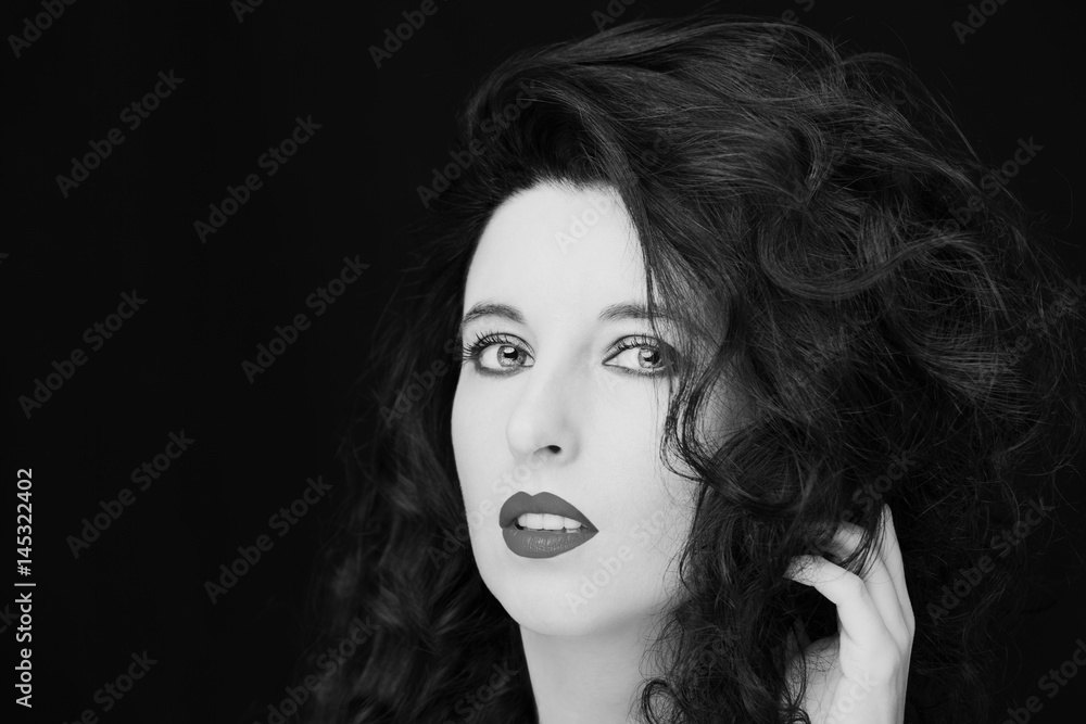 Young attractive woman with long black hair on dark background. Young attractive woman with long black hair on dark background.