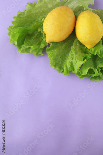 lemons and salad on violet background