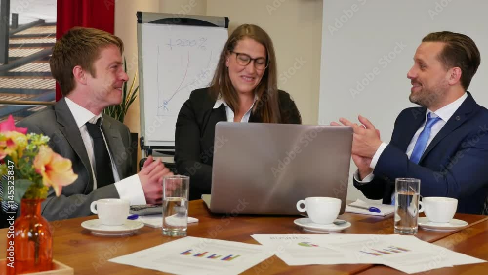 Businesspeople discussing together in conference room during meeting at office, showing stats on laptop, they applaud for positive results Businesspeople discussing together in conference room during meeting at office, showing stats on laptop, they applaud for positive results