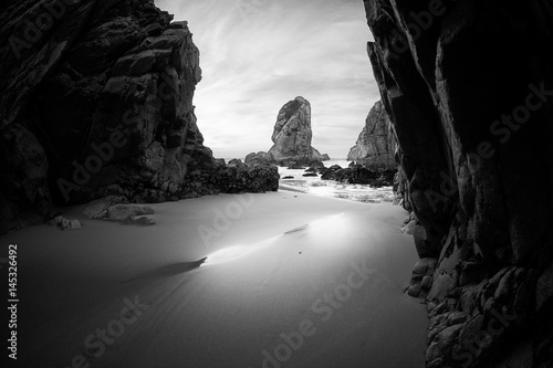 Black and white photo of rocky coastline of Atlantic ocean