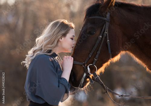 Young beautiful elegance modern woman posing with horse photo