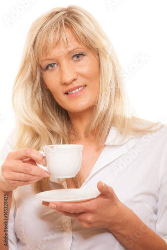 Mature woman drinking tea or coffee..