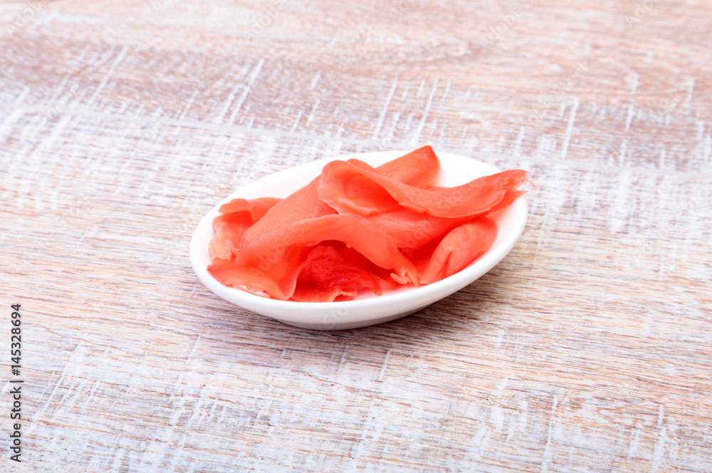 Bowl with ginger on wooden background. Japanese cuisine. Asia food. Bowl with ginger on wooden background. Japanese cuisine. Asia food.
