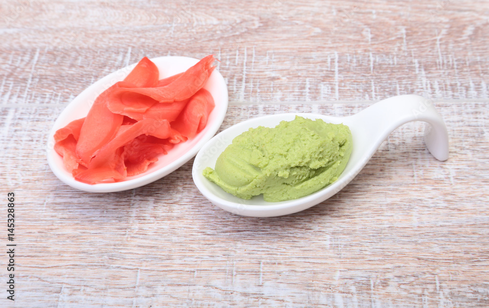Bowl with Wasabi and ginger on wooden background. Japanese cuisine. Asia food. Bowl with Wasabi and ginger on wooden background. Japanese cuisine. Asia food.