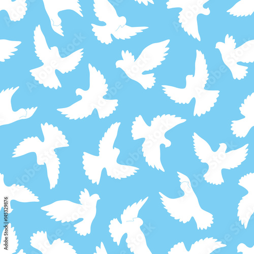 White doves seamless pattern on a blue background.