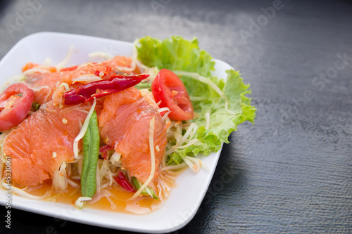 Delicious spicy papaya salad with fresh salmon