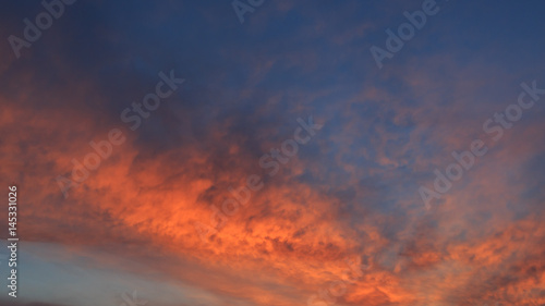 Spring orange clouds on the sky at the dawn for background