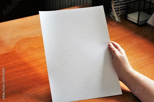 A image of a hand, or hands with paper