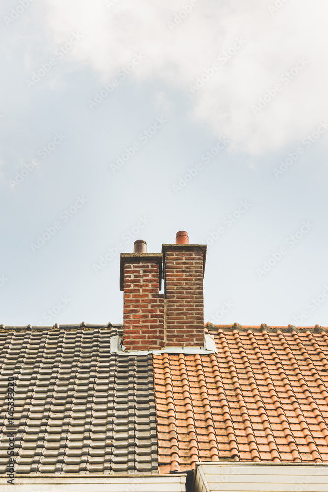 Two chimneys on different colored roofs Two chimneys on different colored roofs
