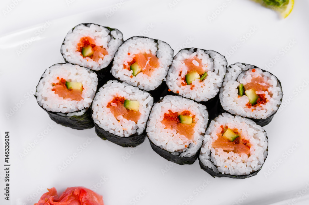Asia. Rolls with salmon (red fish) on a white plate on a white background Asia. Rolls with salmon (red fish) on a white plate on a white background