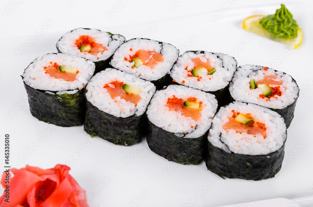 Asia. Rolls with salmon (red fish) on a white plate on a white background Asia. Rolls with salmon (red fish) on a white plate on a white background