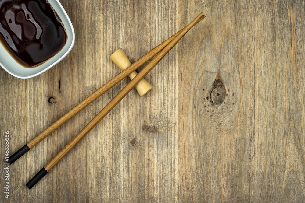 chopsticks and soy sauce on wooden table background with copy space chopsticks and soy sauce on wooden table background with copy space