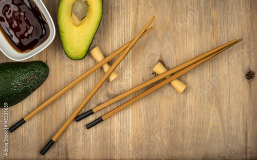 chopsticks and soy sauce on wooden table background with copy space