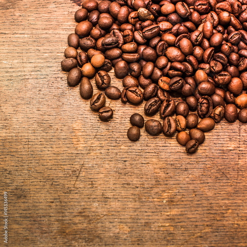Coffee beans on a grunge wooden background